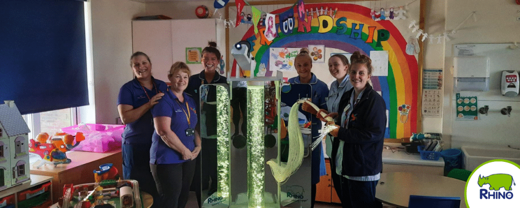 A group of nurses pose with a Sensory Voyager trolley.