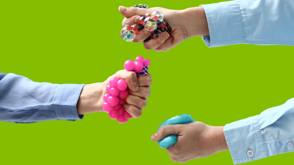 several hands holding squishy stress balls.