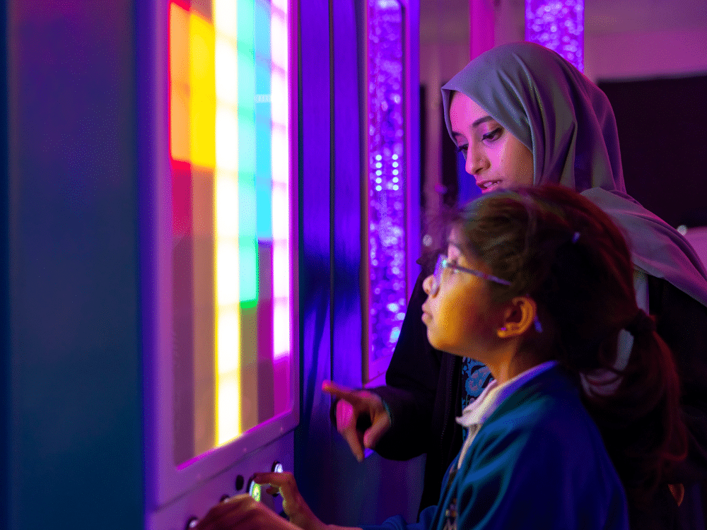 A teacher and a pupil interact with the sound and light panel