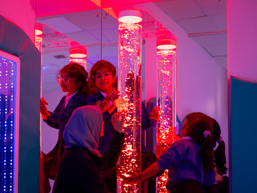 Students touch and explore the bubble tube