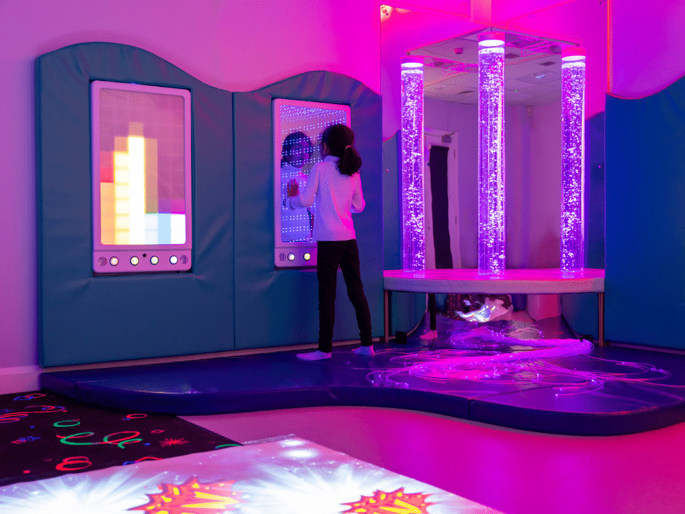 A girl examines the endless light effects inside the infinity tunnel