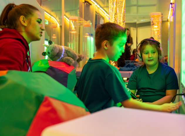 Children with a teacher inside a sensory room