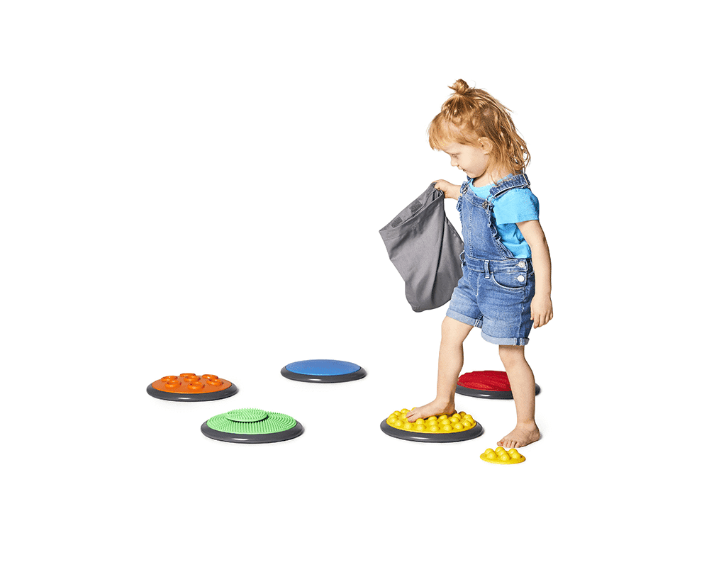 Child walking across the Tactile Disk Set