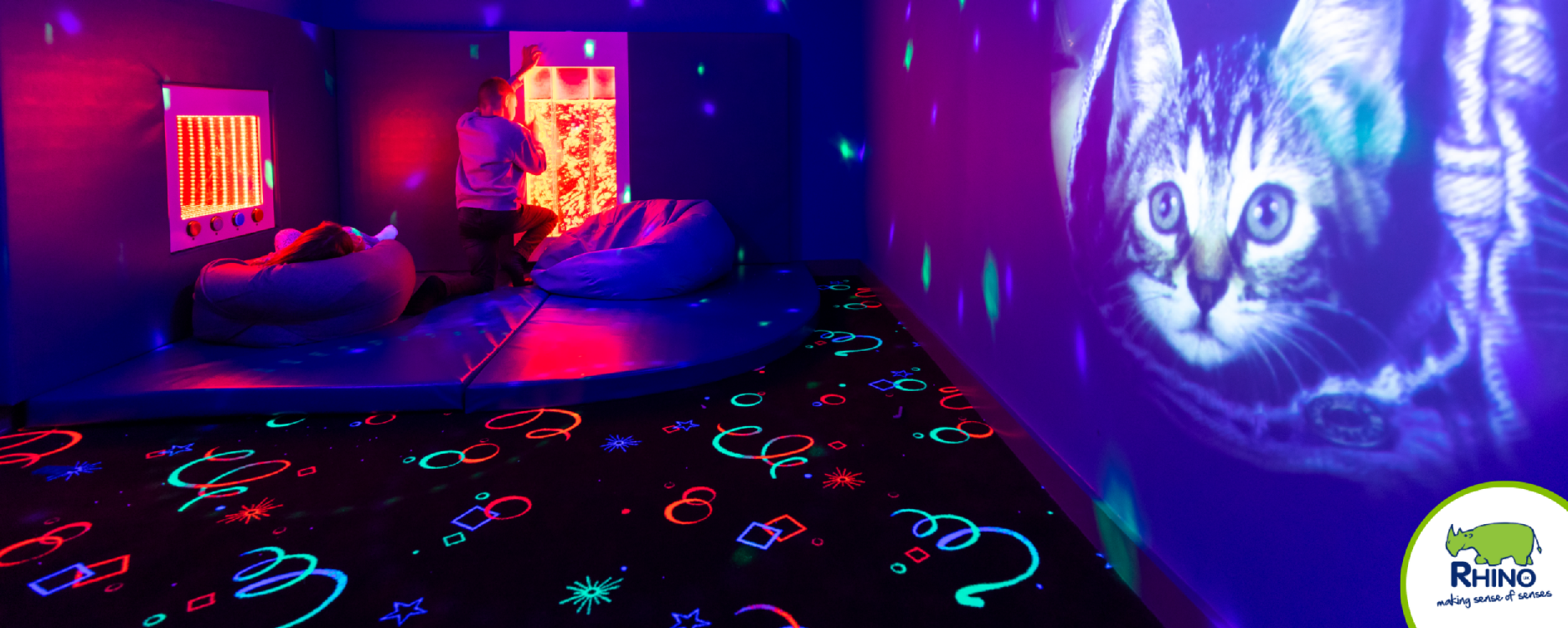 Sensory room with UV lights and a glowing retro UV Carpet