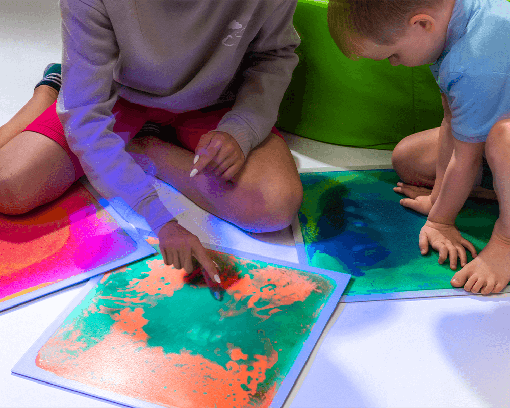 Children playing with UV Sensory Liquid Floor Tiles